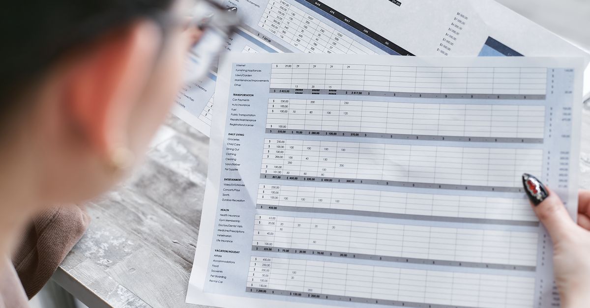 Reviewing printed financial spreadsheets and charts